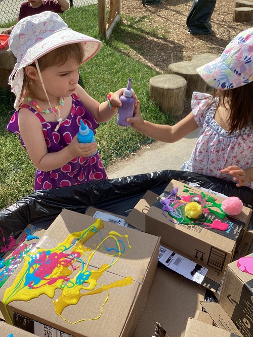 Children exploring with coloured glue