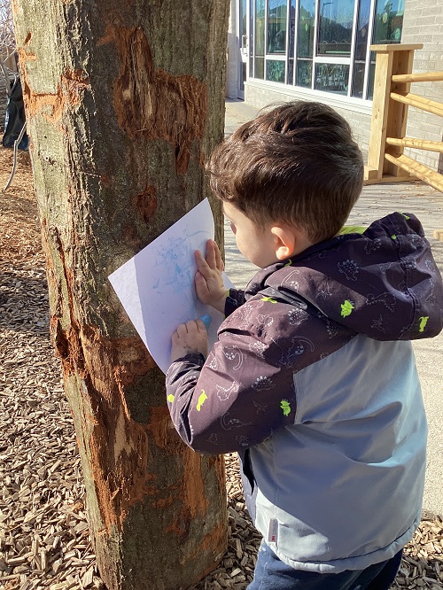 A child doing chalk-rub on a wacky post