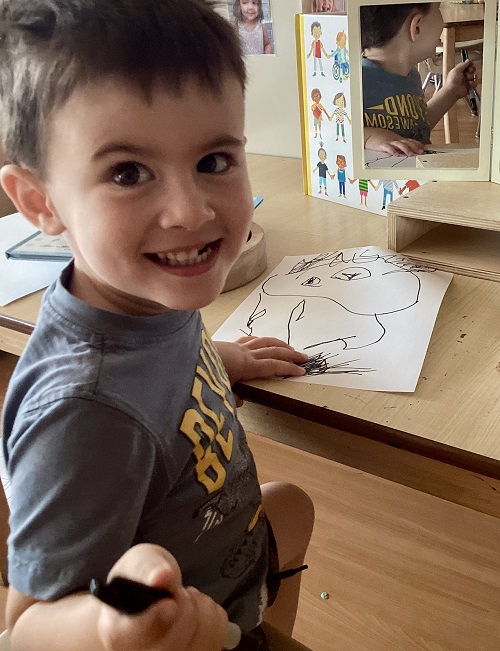 A child working on their self-portrait.
