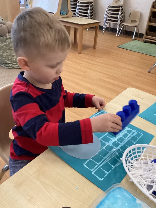 A child working on their artistic creation.