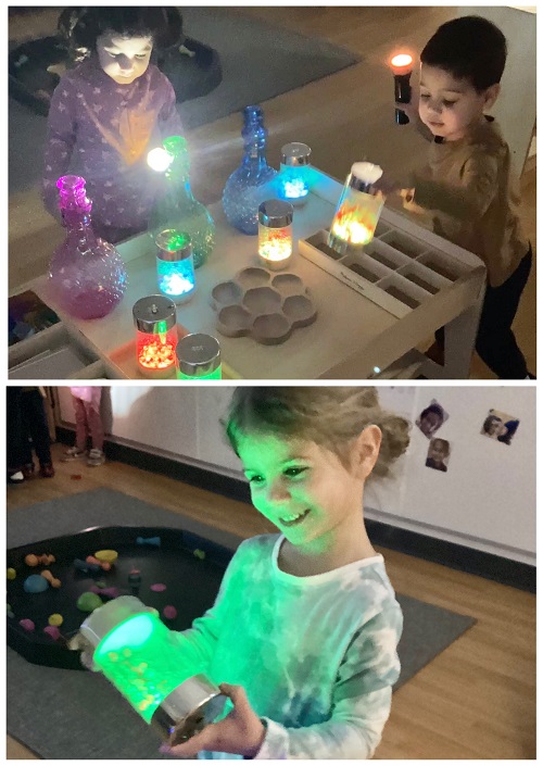 Children exploring with different light producing items.