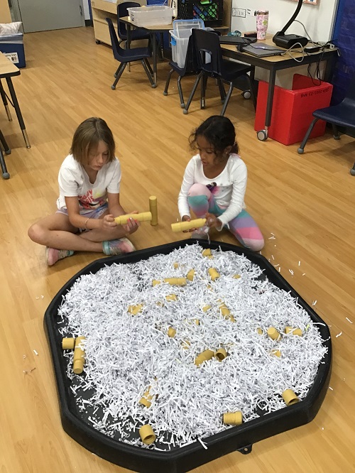 2 school age children working at the tuff tray