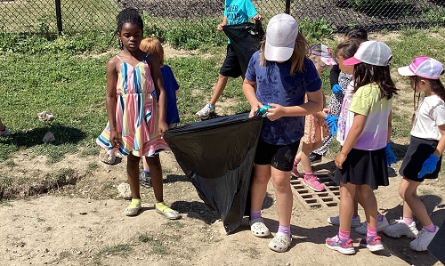 Children in the school field picking up litter