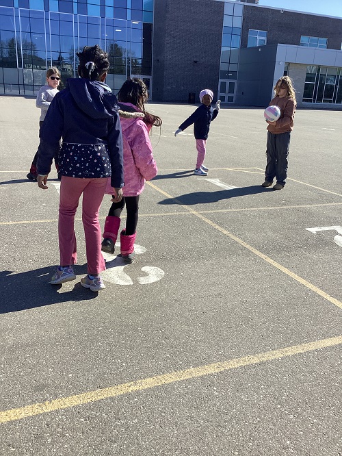 A group of children playing a ball game.