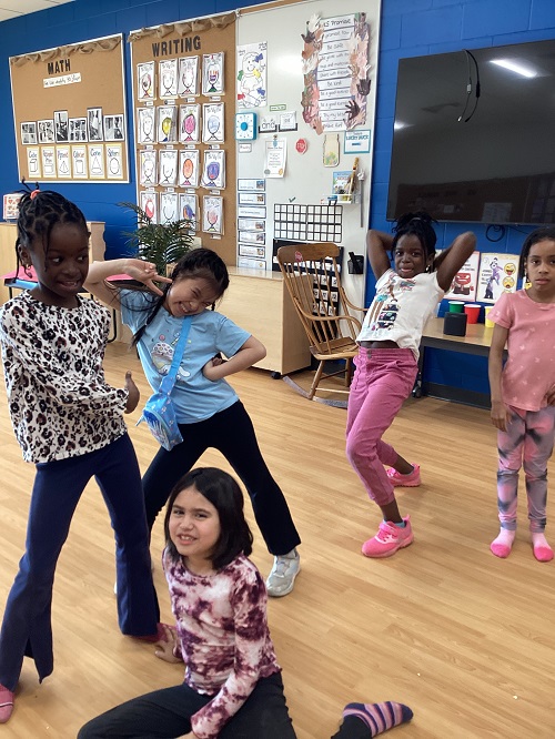 A small group of children engaging in dance.