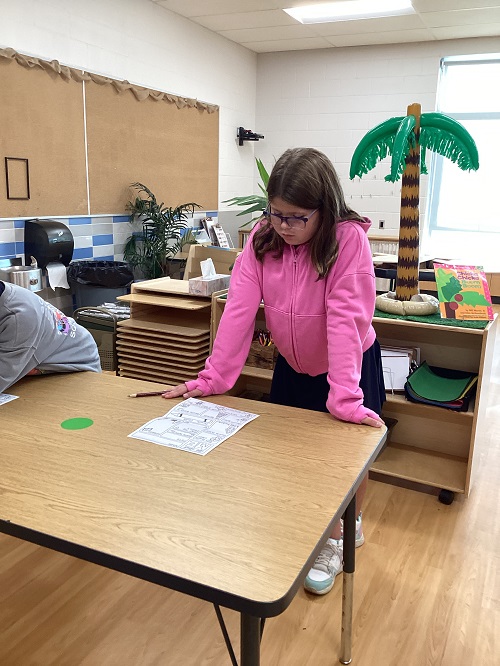 School age child working at a table 