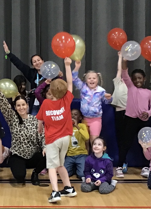 A group of children displaying their balloons.