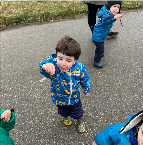 A child holding a worm they found