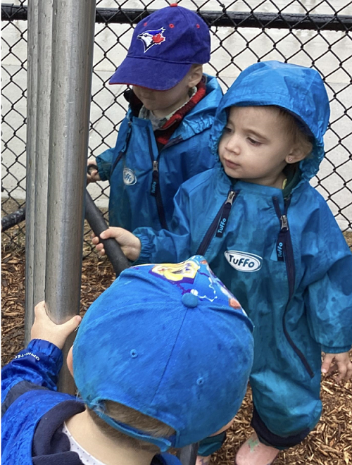 A small group of children exploring the chime tubes with mallets and their hands