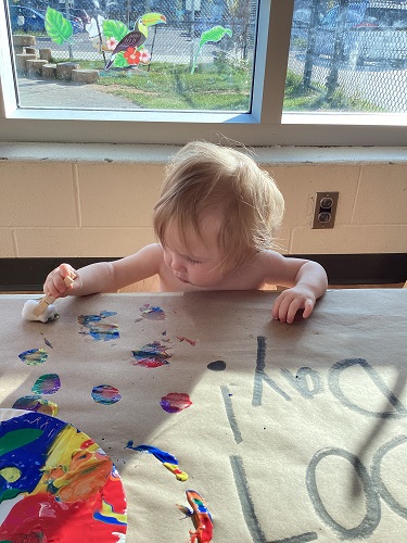 A child exploring with paint.
