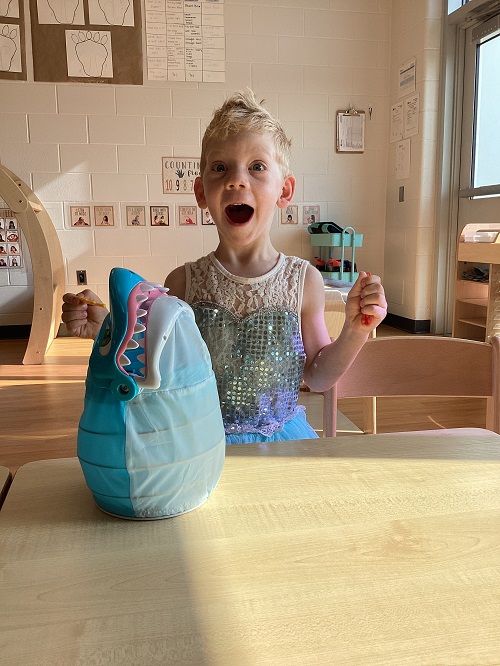 A child with a look of surprise while playing a game.