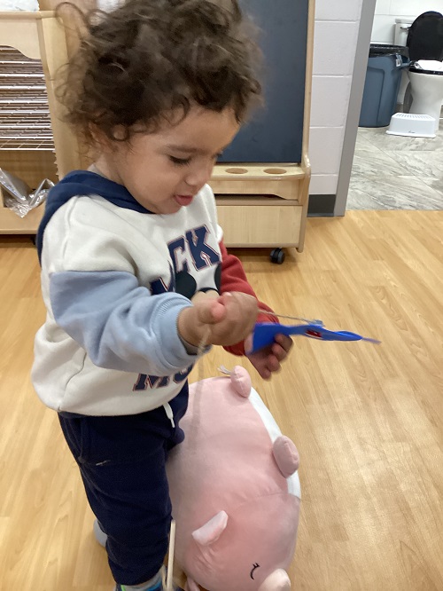 A child holding a magnetic fish.