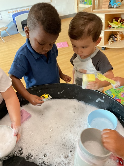 2 children playing is soapy water