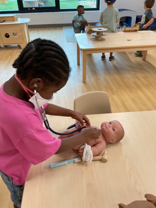 little girl in pink giving a check up