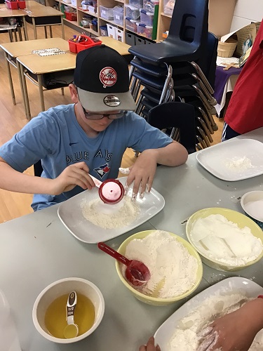 A child measuring flour