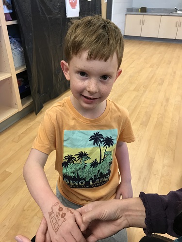 A child showing his henna tattoo