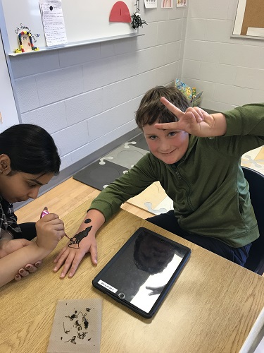 Child getting a henna tattoo