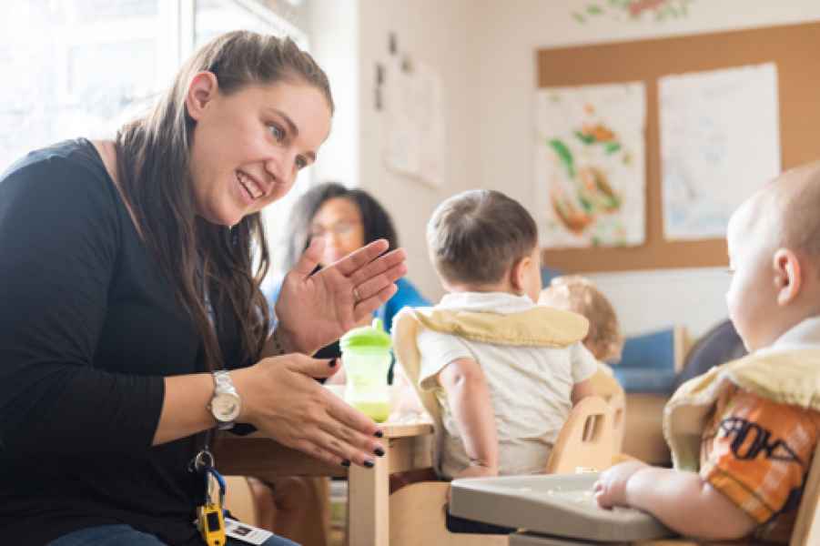 eductor entertaining infants while they eat