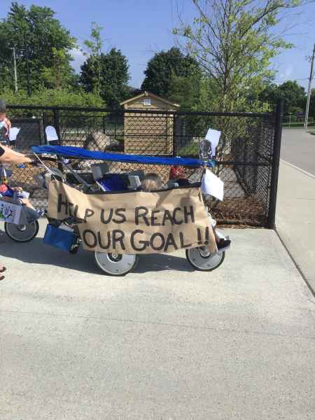 infant stroller with sign promoting fundraiser