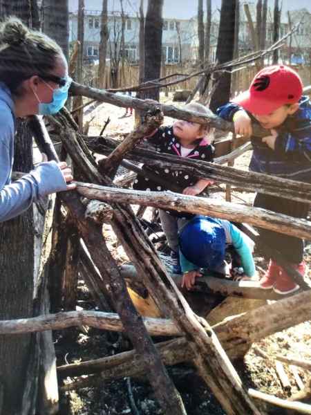 children climbing logs in a forest