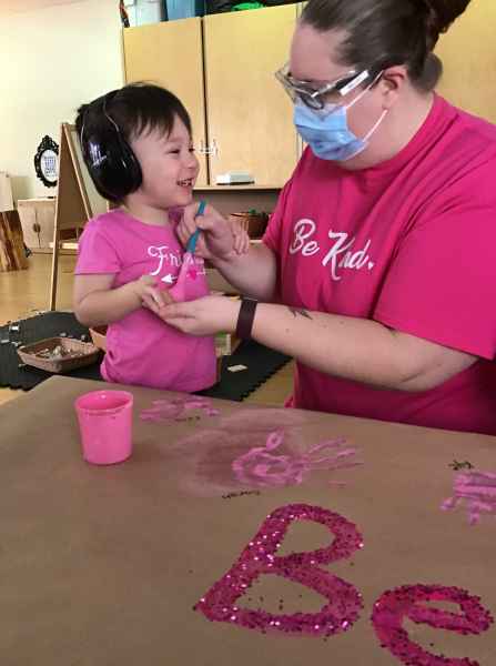 educator painting a child