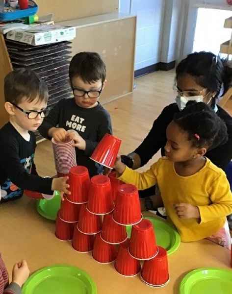 children stackign plastic cups