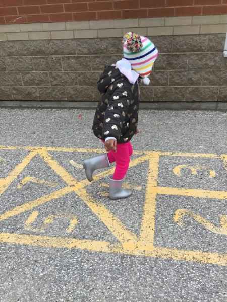girl doing hop scotch