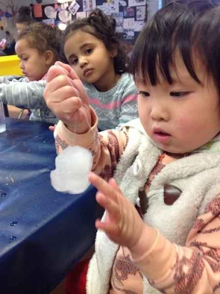 girl touching an ice cube