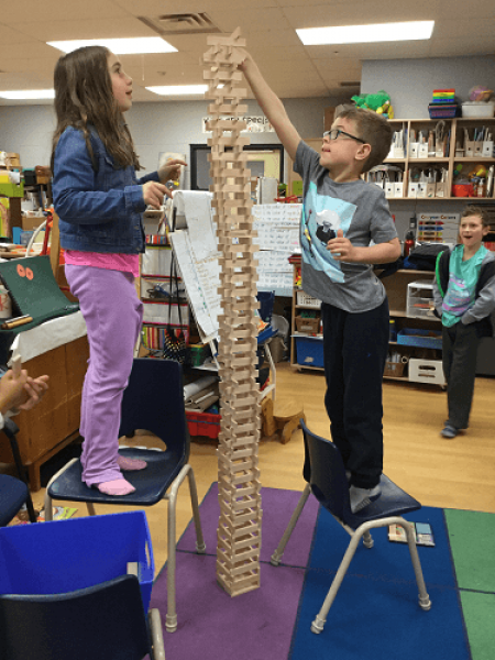 children building a massive jenga tower