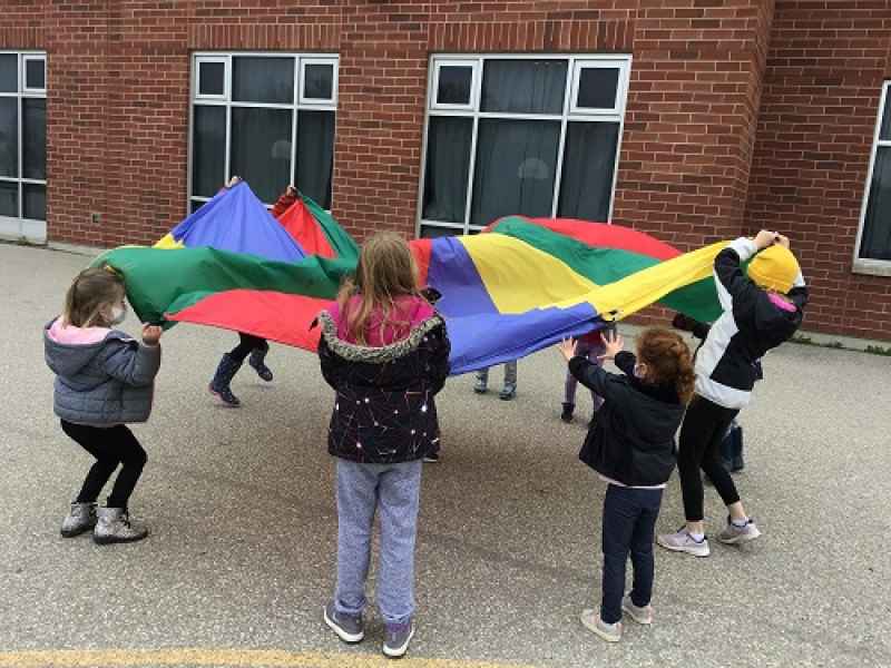 children playing with a parachute