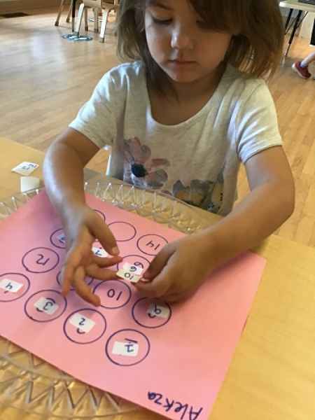 child doing a numer match