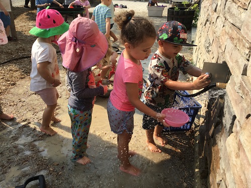 children at water with bowls