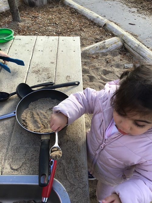 child with spoon and pan