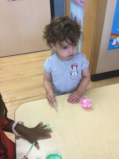 child at the table engaged in sensory play