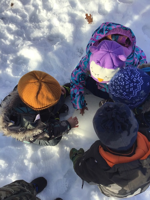 children exploring the snow