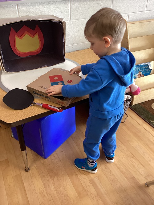 child playing with pretend pizza