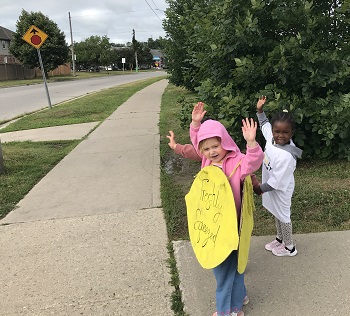children standing outside at our lemonade stand fundraiser