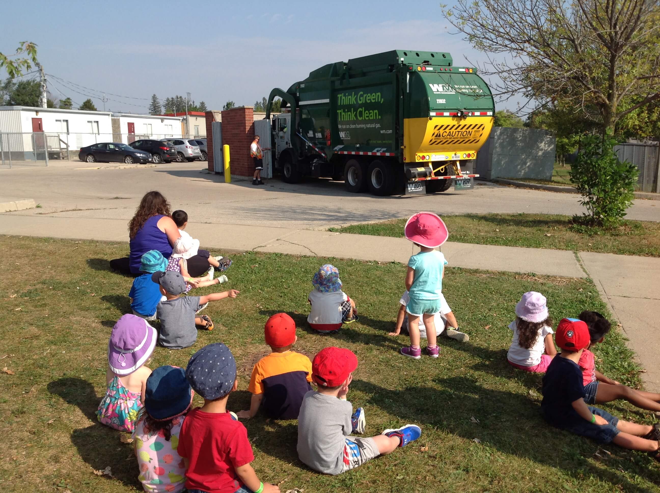 children watching a garbage truck