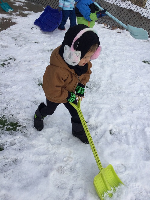 boy pushing a shovel