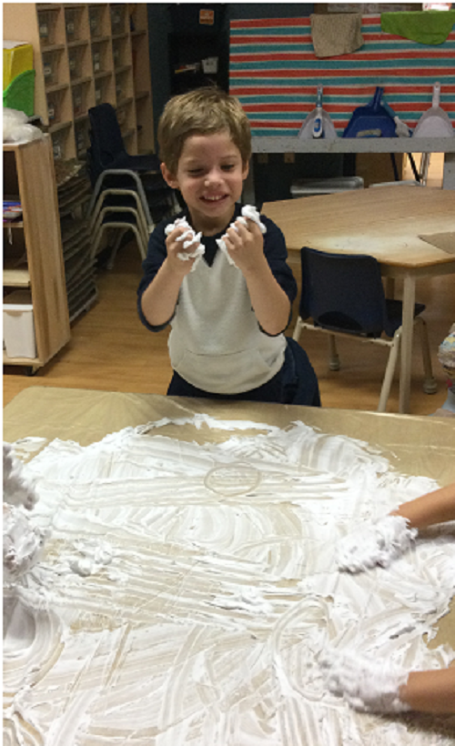 1 boy squishing shaving cream