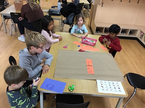 group of children sitting at a table