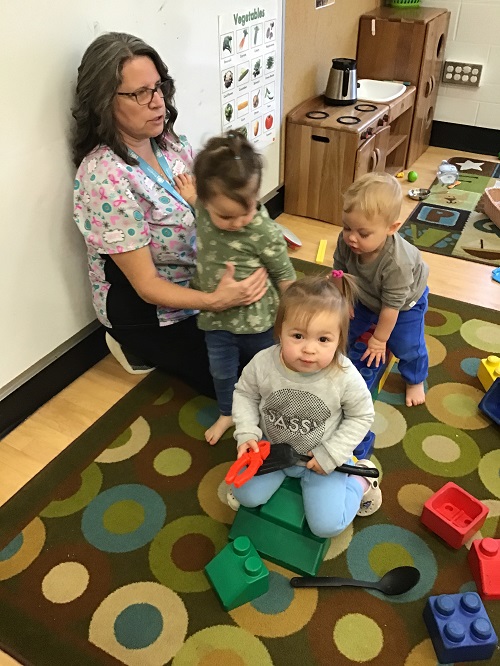 Children sitting on blocks