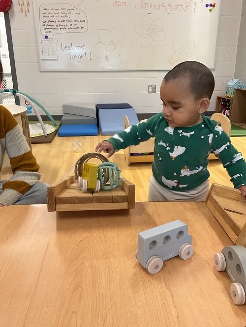 The infants had the opportunity to experiment gravity by rolling different kinds of toys down three textured ramps, navigating through sensory exploration, science, hand-eye coordination and cause and effect.