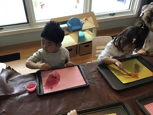 Child using paint brushes