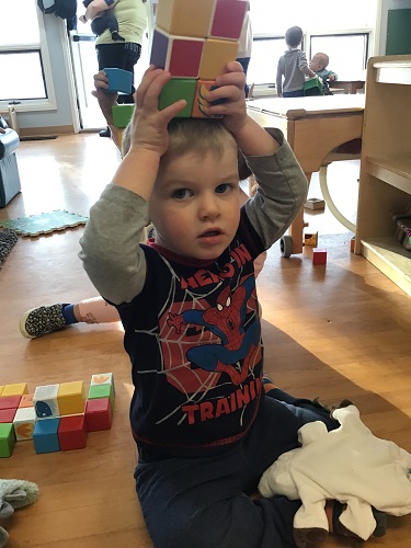 child has toy in hands