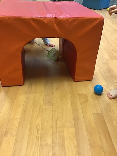 The tunnel part of climber has been set out to see if the toddlers can swipe or swap the balls through the tunnel.