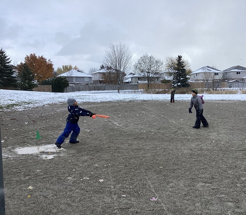 School age children playing baseball