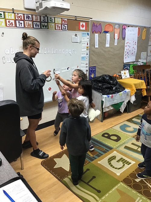 children handing over the letters they found