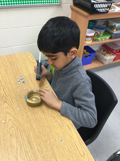 child using hot glue gun