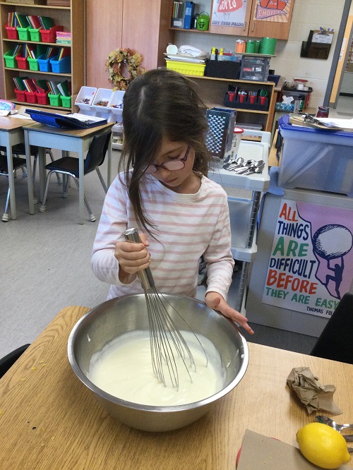 child mixing ingredients in a bowl